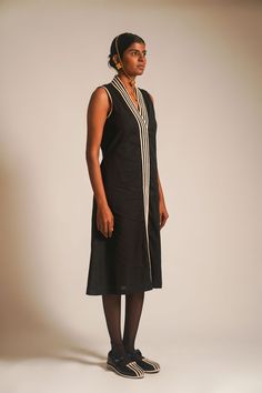 Introducing our black sleeveless long dress, a quintessential piece for summer sophistication. Crafted from breathable cotton, the dress features an overlapped neckline with delicate dori details, exuding timeless charm. A front placket adds a touch of elegance, while a single dori detail on the sleeve line creates subtle allure. Complete with convenient side pockets, this dress seamlessly combines comfort and style, making it the perfect choice for chic summer wear.The model is 5'9'' and wearing S.Material: 100% CottonCare: Dryclean Only Elegant Black Cotton Maxi Dress, Black Sleeveless Linen Dress For Summer, Black Sleeveless Linen Dress For Spring, Sleeveless Black Linen Dress For Spring, Chic Black Sleeveless Linen Dress, Elegant Black Sleeveless Linen Dress, Sleeveless Cotton Maxi Dress For Work, Black Fitted Cotton Sleeveless Dress, Black Sleeveless V-neck Dress For Daywear