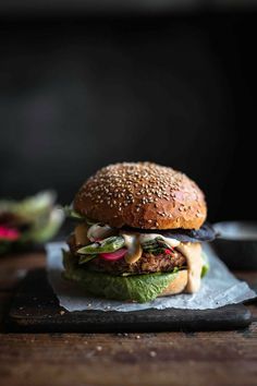 a hamburger sitting on top of a wooden table