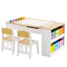 a wooden table with two chairs next to it and a white board on the top