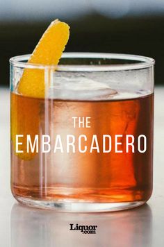 the embarcadero cocktail is served in a glass with an orange slice on top