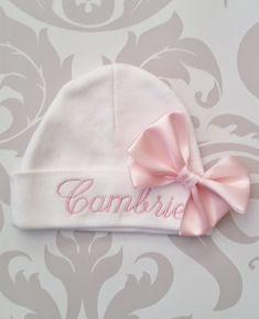 "100% cotton, Personalized, embroidered cap. Includes one name embroidered in light pink and satin bow. Other colors and fonts can be used upon request. Makes a great baby shower gift. If you need a rush order or have a special request or question, please message me through Etsy. Please be sure to include name info in the \"notes to seller\" box that can be found once an item is added to your cart. Caps and headbands are one size and stretch greatly to accommodate many shapes and sizes. Please a Hat Personalized, Pregnancy Gender, Silhouette School, Embroidered Cap, Embroidered Name, Hand Knit Hat, Baby Organization