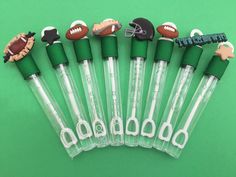 football themed pens are lined up on a green surface