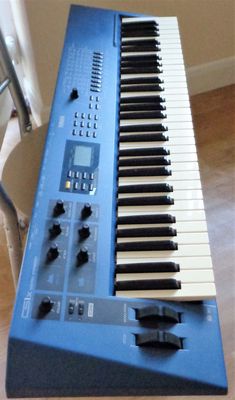 an electronic keyboard sitting on top of a blue table