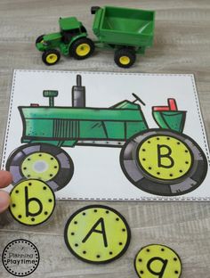 a green tractor with the letter b in front of it and matching letters to match