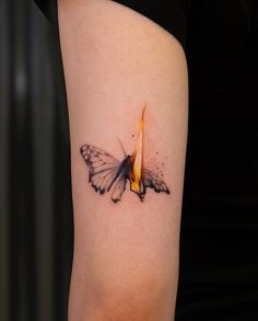 a small butterfly tattoo on the right thigh with a flame coming out of it's wings