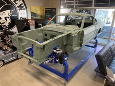 an old car being worked on in a garage