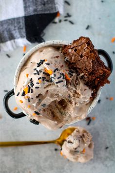 two scoops of ice cream with sprinkles and chocolate cake on top