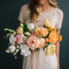 a woman holding a bouquet of flowers in her hands