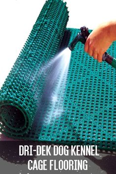 a person spraying water on a green mat with the words dri - dek dog kennel cage flooring