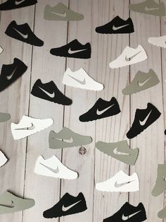 several pairs of shoes are on the floor with some cut outs in them to make it look like they have been made out of paper