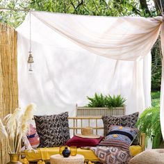 an outdoor seating area with pillows and blankets