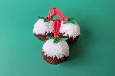 two christmas cupcakes are decorated with red and white frosting on green background