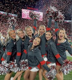 the cheerleaders are all dressed in black and red