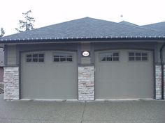 two garage doors are open in front of a house