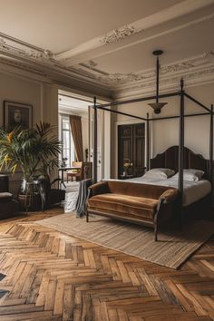 a bed sitting in the middle of a bedroom next to a chair and potted plant