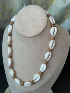 "This Native Treasure Authentic Tropical  Jewelry Cowrie Shell Necklace is Beautifully Hand-Crafted in our Tropical Jewelry Shop by our own Native Island Artisans using up to  1\" Long Hand-Selected Super  Class 'A' Quality Cowrie Shells.  Select your size from 14\" to 24\" inch length, priced accordingly. 8mm (5/16\") Real wood Coco Beads and  'Good Karma' Cowrie Shells Indigenous to  the Powder White Beaches of the Philippines. Perfect to take that Tropical Feeling with You! Truly Native Treas Cowrie Shell Jewelry Tutorial, White Beach Jewelry With Wooden Beads, White Wooden Beads Jewelry For Beach, White Wooden Beads Jewelry For The Beach, White Wooden Beads Necklace For Vacation, Cowrie Shell Jewelry Necklaces, Wood Bead Jewelry, Cowrie Necklace, Afro Jewelry