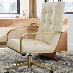 a white office chair sitting on top of a rug in front of a desk with a mirror