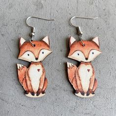 Bring a touch of the forest to your look with these Adorable Woodland Fox Earrings. The intricate and detailed design captures the playful spirit of these clever creatures, making them the perfect accessory for nature lovers and animal enthusiasts. The lightweight and comfortable design make them perfect for all-day wear, and they are sure to add a touch of whimsy and charm to any outfit. They measure just under 2 inches in length. Metal: Zinc Alloy, good for 99% of allergies including nickel Ear Drop, Fox Earrings, Woodland Fox, Fox Ears, Book Jewelry, Animal Earrings, Yellow Earrings, Game Dresses, Holiday Jewelry