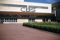 a building with a sign that says cbs on the front and side of it