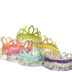 five different colored hair brushes with tiaras on them