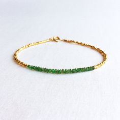 "This is a genuine Emerald bracelet made of high quality natural Emerald beads and sterling silver bead plated with 24k gold. The total length for this bracelet is 7\". There is no extender for this bracelet. This gemstone bracelet is simple and elegant. The dainty gold bracelet is great to layer with other tiny gold bracelet. Measurement: 2 mm Emerald for 1.5\" long 7\" Long More Gemstone Bracelets https://www.etsy.com/shop/SforSparkleShop?ref=seller-platform-mcnav&section_id=19112914 Gift Emerald Bracelet Gold, Bracelet Emerald, Dainty Gold Bracelet, Bracelet For Her, Emerald Bracelet, Basic Jewelry, Emerald Bead, Birthstone Bracelet, May Birthstone