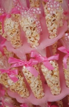 some kind of candy sticks with pink bows on it's ends and ribbons around them