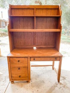 an old wooden desk with two drawers and a bookcase on it's side