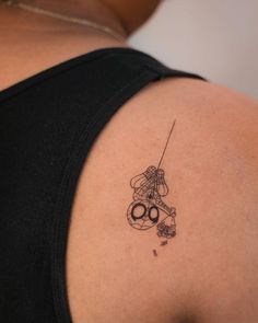 a woman with a tattoo on her shoulder and scissors in the other side of her arm