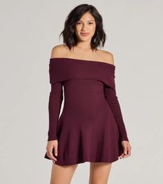 a woman is wearing a dress with off the shoulder sleeves and high low heeled boots