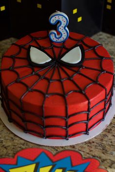 a spiderman birthday cake with the number three on it's face and eyes