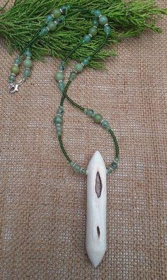 Curious chunky willow wood talismanic necklace.  Heavily scarred  to one side, smooth white willow wood to the other. On a necklace chain of 8 mottled green jade, 6mm prehnite beads and pale green crystal. Solace, or perhaps consolation, comfort, given when times are hard, when you are distraught or disappointed by someone or something, when you are in need of support in your misery. Which is exactly what willow does. She does not take your pain or grief away, but she does support you through it Nature-inspired Green Jewelry With Wooden Beads, Green Spiritual Necklace With Wooden Beads, Spiritual Green Necklace With Wooden Beads, White Wooden Beads Necklace For Healing, Willow Wood, White Willow, Green Crystal, Green Jade, Green Crystals