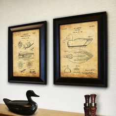 two framed drawings on the wall above a wooden desk with a rubber duck in front of it