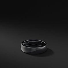 a black ring on a dark surface with no one in the photo looking at it