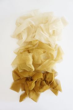 several pieces of yellow tulle sitting on top of each other