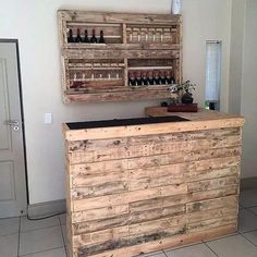 a bar made out of pallet wood with bottles on it