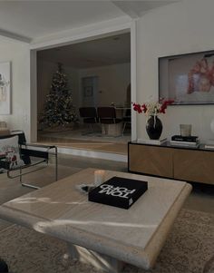 a living room filled with furniture and a christmas tree