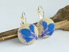 Handmade earrings with embroidered blue flower. The pattern is designed by me and embroidered by me too. I use the maximal quantity of colors in each embroidery picture to make it more realistic and colorful.These earrings look very gently and delicately, perfect spring accessory.These blue flowers are embroidered on linen fabric by cotton embroidery floss.Details: each round is 20 mm (0,8" ); total length of earring is 32 mm (1,3"); material: brass earring base, cotton. Hand Embroidered Gifts, Cross Stitch Floral, Hand Embroidered Jewelry, Rabbit Jewelry, Embroidered Earrings, Earrings Cross, Stitch Jewelry, Bunny Earrings, Necklace Ideas