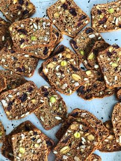 several pieces of bread with nuts and seeds on top