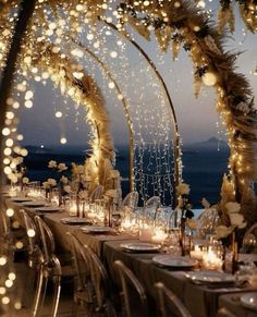 an outdoor dining area decorated with lights and pamolite garlands for a wedding reception