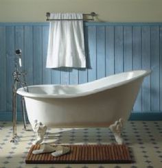 an old fashioned bathtub in a blue bathroom