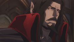 a man with long black hair wearing a red cape