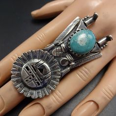 "NAVAJO SUN FACE TURQUOISE KACHINA RING DESCRIPTION: This impressive ring will be a treasured addition to your collection of fine vintage Native American jewelry. MEASUREMENTS: Ring face measures 2 3/8\" x 1 1/8\" Cabochon measures 15mm x 13mm RING SIZE: 8 1/2 WEIGHT: 31.0 grams SIGNED: no STERLING: yes, stamped STERLING" Artisan Stamped Rings As Collectibles, Collectible Engraved Turquoise Ring, Vintage Adjustable Engraved Turquoise Ring, Vintage Silver Concho Ring, Vintage Concho Ring Jewelry, Vintage Adjustable Concho Rings, Vintage Turquoise Concho Ring, Southwestern Style Collectible Jewelry Ring, Southwestern Collectible Ring Jewelry