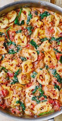 Creamy Tortellini with Sausage, Spinach, Tomatoes, and Mozzarella in a stainless steel skillet Tomato Spinach Cream Sauce, Tortellini With Sausage, Tortellini With Spinach, Mozzarella Cheese Sauce, Spinach Cream Sauce, Creamy Tortellini, Tomatoes And Mozzarella, Sausage Spinach, Tomato Spinach