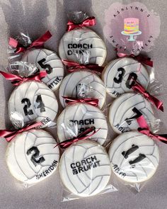 decorated cookies in the shape of volleyballs with ribbons