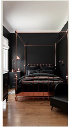 Luxurious black and copper bedroom with a four-poster bed and modern decor.