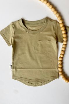 The River Tee is a perfect basic top to throw on your little one for any occasion. Wear it on it's own or use it as a base layer under a jacket. The chest pocket and drop hem give it just enough flair to stand out, and the soft and stretchy fabric is perfect for your little one's skin! Material: 95% Cotton/5% Spandex Wide Leg Linen Trousers, Tube Jumpsuit, Lounge Top, A Jacket, End Of Season Sale, Mini Shirt Dress, Linen Trousers, Basic Tops, Skirt Leggings