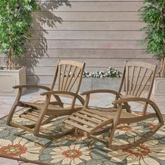 two wooden rocking chairs sitting on top of a rug