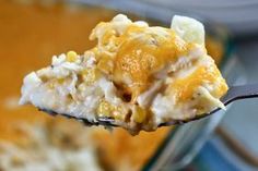 a spoon full of casserole with cheese on it