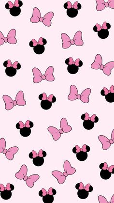 pink and black minnie mouses with bows on them are all over the wallpaper