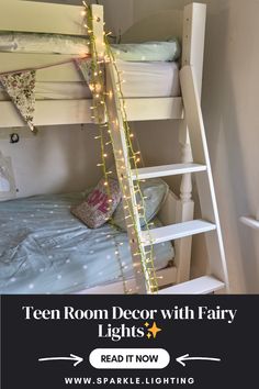 a bunk bed with fairy lights hanging from the ceiling and on top of it is a white ladder